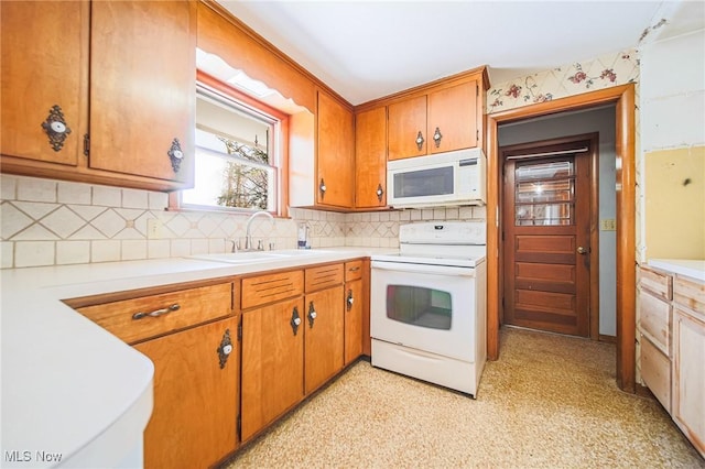 4820 Alabama Ave SW, Navarre, OH 44662 - kitchen with backsplash, light countertops, a sink, and white appliances