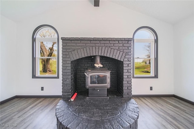 4820 Alabama Ave SW, Navarre, OH 44662 - details with baseboards, a wood stove, and wood finished floors