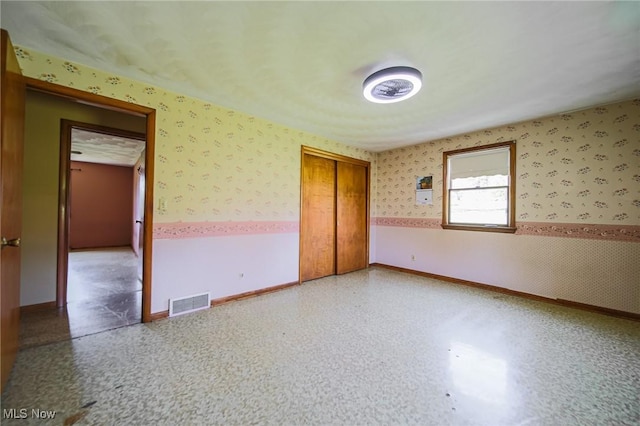 4820 Alabama Ave SW, Navarre, OH 44662 - unfurnished bedroom featuring wallpapered walls, visible vents, and baseboards