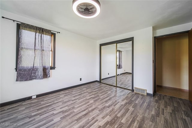4820 Alabama Ave SW, Navarre, OH 44662 - unfurnished bedroom with a closet, visible vents, wood finished floors, and baseboards