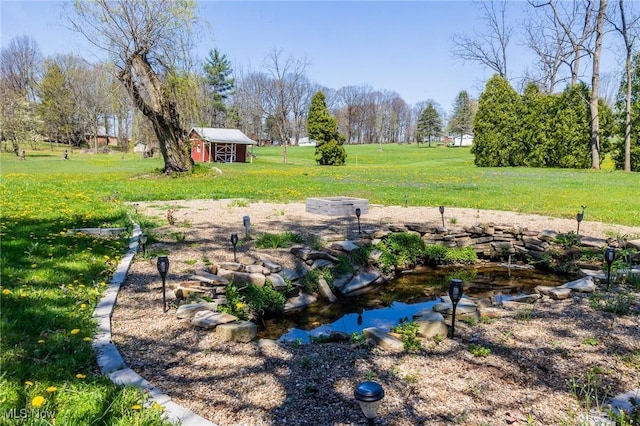 4820 Alabama Ave SW, Navarre, OH 44662 - view of yard with an outbuilding, a shed, and a small pond