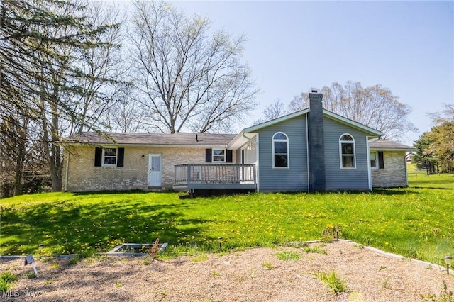 4820 Alabama Ave SW, Navarre, OH 44662 - rear view of house with a yard, a deck, a chimney, and brick siding