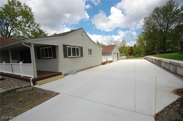 view of property exterior featuring a porch and a garage