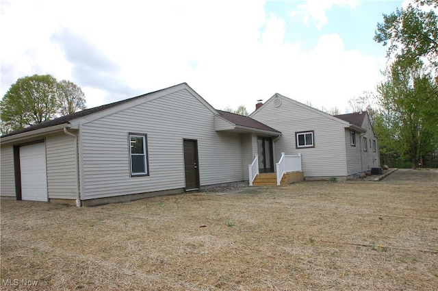 back of house featuring a garage