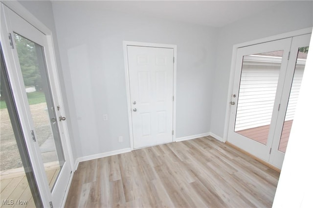 spare room with light wood-style floors and baseboards