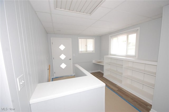 entryway with a paneled ceiling, visible vents, and wood finished floors