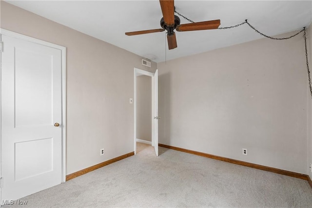 unfurnished bedroom with baseboards, carpet flooring, visible vents, and a ceiling fan