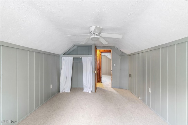 additional living space with a ceiling fan, a textured ceiling, and vaulted ceiling