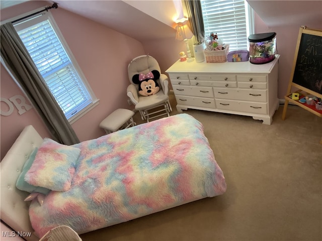carpeted bedroom with lofted ceiling
