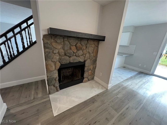 1279 Lander Rd, Mayfield Heights, OH 44124 - unfurnished living room with wood finished floors, baseboards, and a stone fireplace