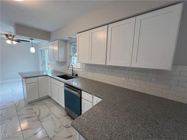 1279 Lander Rd, Mayfield Heights, OH 44124 - kitchen featuring a peninsula, dishwashing machine, a sink, white cabinetry, and marble finish floor