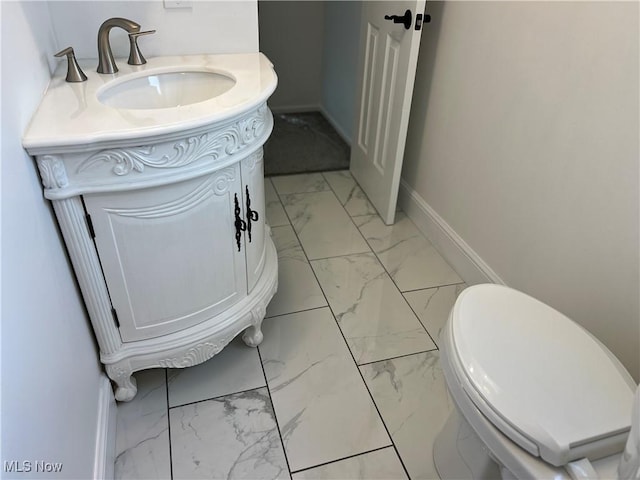 1279 Lander Rd, Mayfield Heights, OH 44124 - bathroom featuring toilet, baseboards, marble finish floor, and vanity