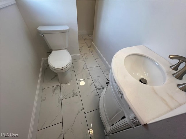 1279 Lander Rd, Mayfield Heights, OH 44124 - bathroom with toilet, marble finish floor, and baseboards