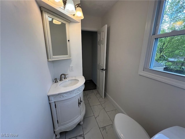 1279 Lander Rd, Mayfield Heights, OH 44124 - half bathroom with vanity, toilet, baseboards, and marble finish floor