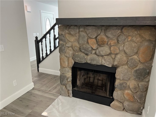 1279 Lander Rd, Mayfield Heights, OH 44124 - room details with baseboards, a fireplace, visible vents, and wood finished floors