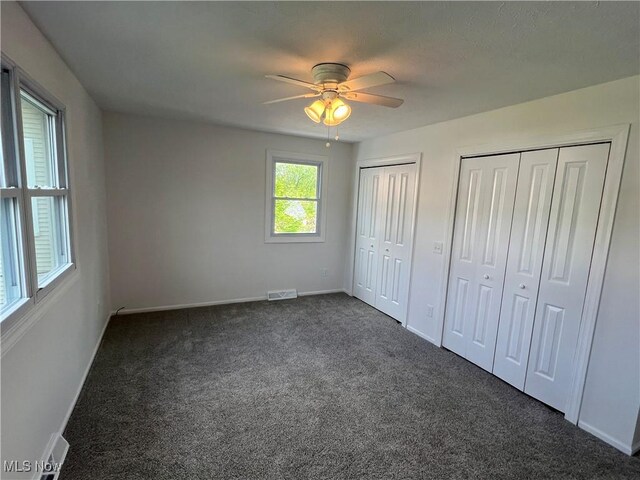 1279 Lander Rd, Mayfield Heights, OH 44124 - unfurnished bedroom with a ceiling fan, carpet, baseboards, visible vents, and two closets