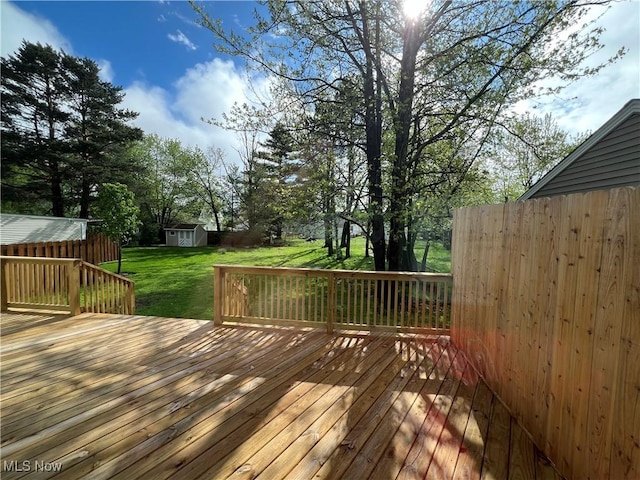 1279 Lander Rd, Mayfield Heights, OH 44124 - deck with a lawn, an outbuilding, a storage shed, and fence