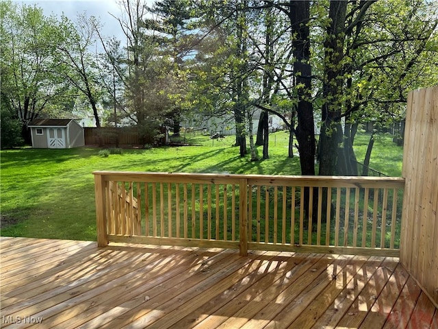 1279 Lander Rd, Mayfield Heights, OH 44124 - wooden terrace featuring a storage unit, a fenced backyard, an outbuilding, and a lawn