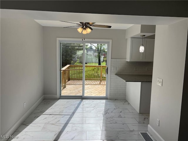 1279 Lander Rd, Mayfield Heights, OH 44124 - unfurnished dining area with marble finish floor, baseboards, and ceiling fan