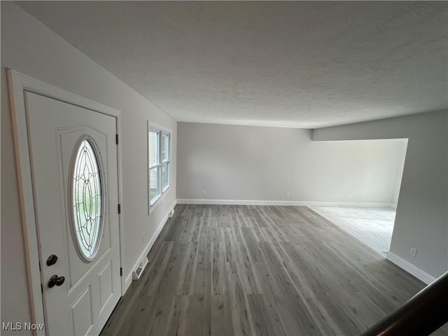1279 Lander Rd, Mayfield Heights, OH 44124 - foyer featuring baseboards, a textured ceiling, and wood finished floors