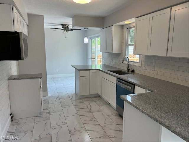 1279 Lander Rd, Mayfield Heights, OH 44124 - kitchen featuring marble finish floor, a peninsula, a sink, and dishwasher