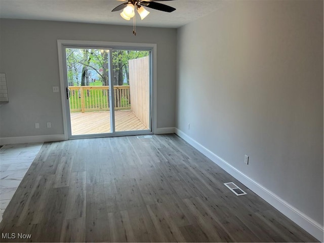 1279 Lander Rd, Mayfield Heights, OH 44124 - empty room featuring a ceiling fan, baseboards, visible vents, and wood finished floors