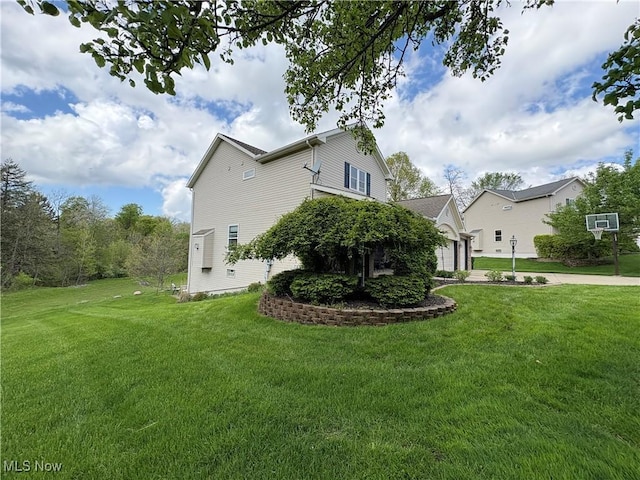 view of side of property with a lawn