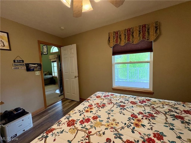bedroom with baseboards, dark wood-style flooring, and ceiling fan
