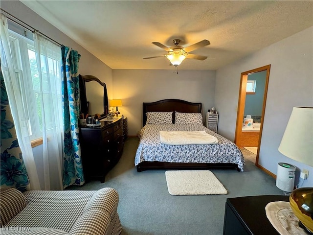bedroom with connected bathroom, carpet floors, a ceiling fan, and baseboards