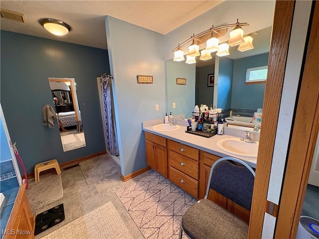 bathroom featuring a sink, double vanity, a shower with curtain, and visible vents