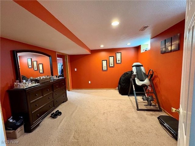 interior space featuring a textured ceiling, carpet, visible vents, recessed lighting, and baseboards