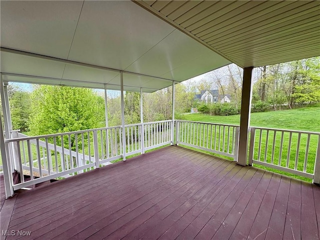 wooden terrace featuring a yard