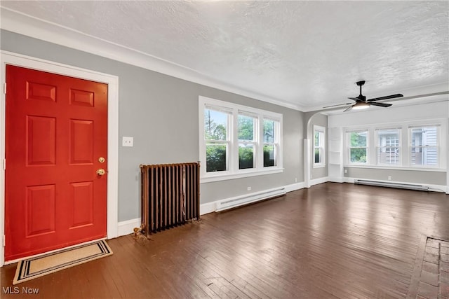 interior space featuring a ceiling fan, baseboard heating, hardwood / wood-style floors, and radiator heating unit