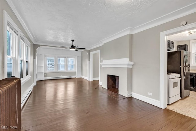 unfurnished living room featuring a ceiling fan, a baseboard radiator, a fireplace, and wood-type flooring