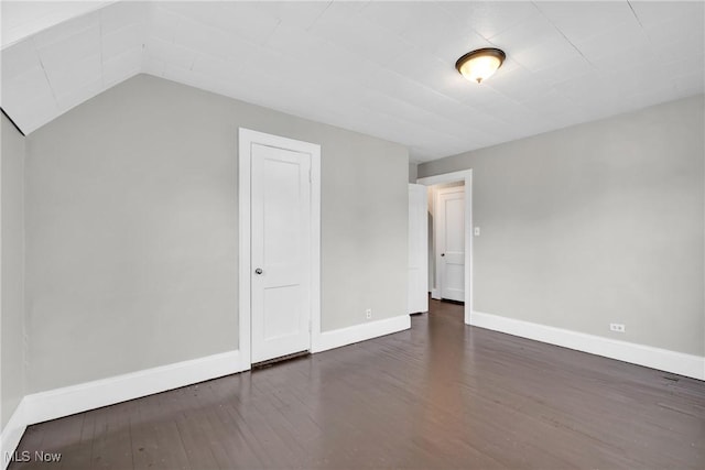 additional living space featuring baseboards and wood finished floors
