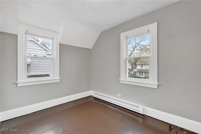 additional living space with lofted ceiling, baseboards, plenty of natural light, and a baseboard heating unit