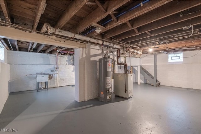 below grade area featuring stairway, gas water heater, and a heating unit