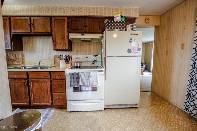 4991 Walnut St, Sugarcreek, OH 44681 - kitchen with light floors, under cabinet range hood, white appliances, a sink, and light countertops