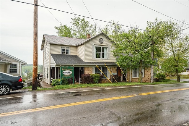 4991 Walnut St, Sugarcreek, OH 44681 - view of front of home with brick siding, roof with shingles, and a chimney