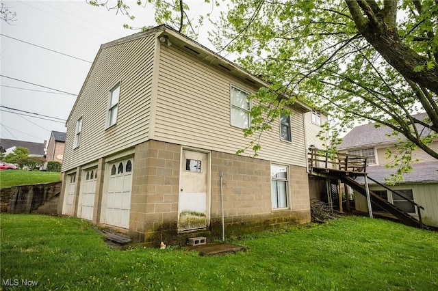 4991 Walnut St, Sugarcreek, OH 44681 - rear view of house with a lawn, stairs, an attached garage, and a deck