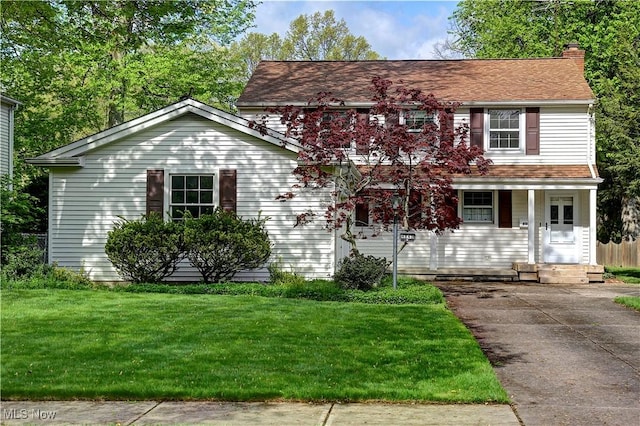 4840 W 228th St, Fairview Park, OH 44126 - view of front of house with a front yard and a chimney