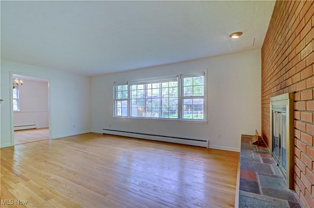 4840 W 228th St, Fairview Park, OH 44126 - unfurnished living room featuring a baseboard heating unit, a fireplace, baseboard heating, wood finished floors, and a chandelier