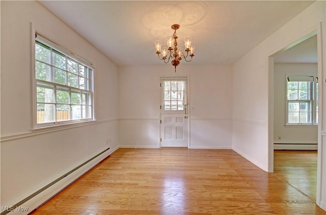 4840 W 228th St, Fairview Park, OH 44126 - unfurnished dining area with a baseboard heating unit, healthy amount of natural light, and a chandelier
