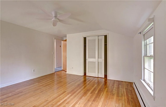 4840 W 228th St, Fairview Park, OH 44126 - unfurnished bedroom with baseboard heating, light wood-style flooring, lofted ceiling, a closet, and a ceiling fan