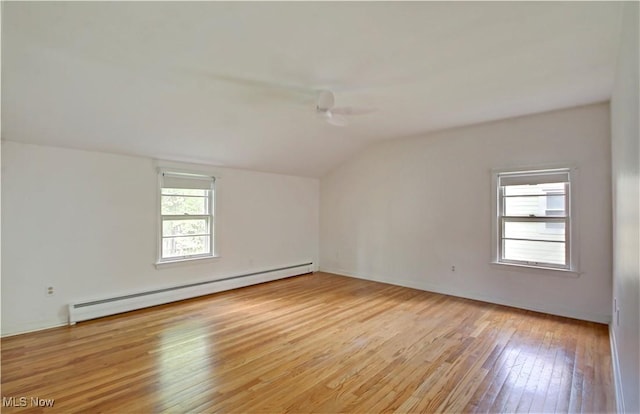4840 W 228th St, Fairview Park, OH 44126 - empty room with baseboard heating, lofted ceiling, and light wood-style flooring