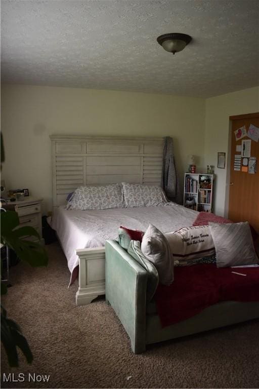 carpeted bedroom with a textured ceiling