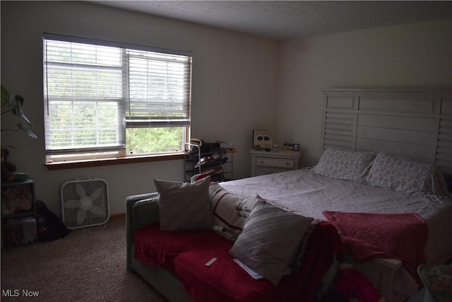 carpeted bedroom with a textured ceiling
