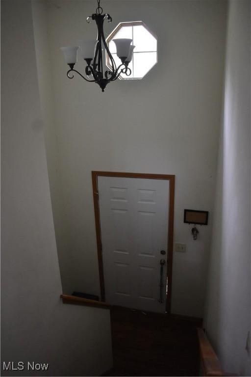 doorway to outside featuring a notable chandelier