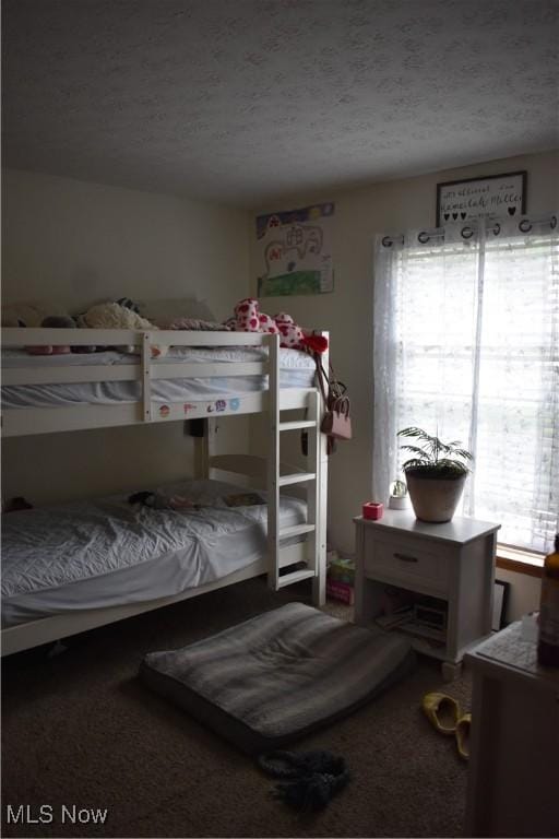 bedroom featuring carpet and a textured ceiling