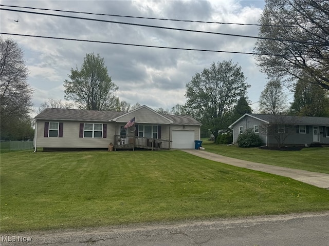 single story home with concrete driveway, an attached garage, and a front yard